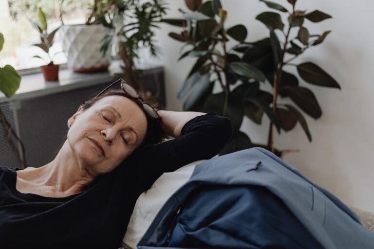 Hooggevoelig op je werk: vrouw ligt moe op de bank na een werkdag